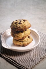 Soft Chocochip Cookies on white plate, served with milk.

