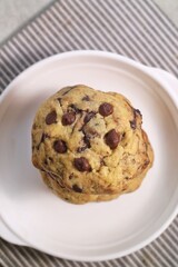Soft Chocochip Cookies on white plate, served with milk.
