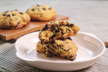 Soft Chocochip Cookies on white plate, served with milk.
