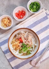 Japanese traditional noodle soup Niku Udon with kakedashi soup, fish stock soup and then topped with sliced beef and sliced scallions.
