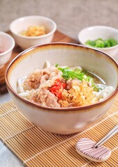 Japanese traditional noodle soup Niku Udon with kakedashi soup, fish stock soup and then topped with sliced beef and sliced scallions.
