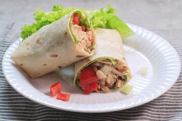Chicken Kebab, wrap chicken with spices and veggetables with mayonaise and spicy sauce.
