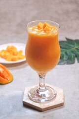 Fresh beautiful delicious mango juice. Close up design concept of smoothie cold drink in glass cup. 
