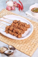 Clam Satay. Sate Kerang. Made from clams, chili, garlic, salt, spices and coconut. 
