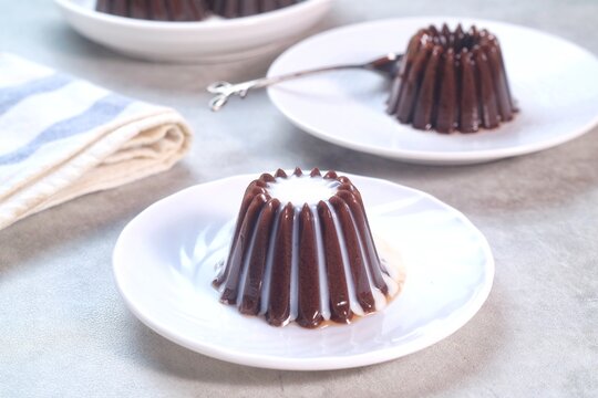 Homemade Dessert Puding coklat or chocolate pudding on white background, have a sweet taste. Made from jelly, cocoa powder, sugar, and milk.
