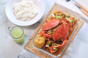 Delicious Crab in Padang sauce or an Indonesian seafood dish of crab served in hot and spicy Padang sauce with corn.
