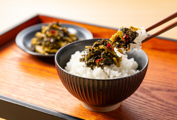 Lifting Karashi Takana and Rice with Chopsticks on a Tray – Karashi Takana: A Japanese-Style Pickle Made from Mustard Greens