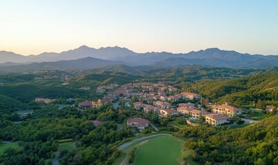 Fototapeta premium Aerial View of Mediterranean Style Homes in a Mountain Valley at Sunset