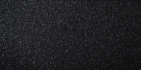 Obraz premium Black textured sandpaper surface with sparkling details.
