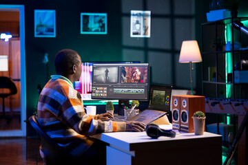 Video editor working on creative software to create a film montage, using color correction wheel and adding visual effects. Male creator editing gradient for movie post production, white balance.