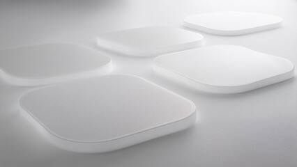 Five white square tiles with subtle textures are arranged against a light gray background, creating a minimalist composition.