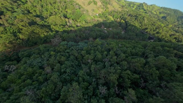 Hatillo Dam with Yuna River surrounded by green mountain landscape of Dominican Republic. FPV forward flight.