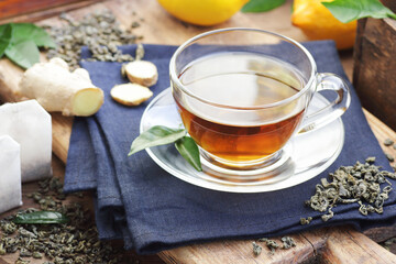 Green chinese tea with lemon and ginger, hot drink immune booster, closeup, natural medicine and naturopathy concept