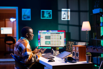 Black man waving on video call and discussing about business infographics, reviewing monthly budget...