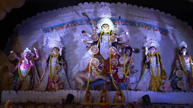 illuminated statues of indian goddess durga with other god goddess in durga pooja