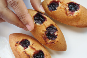 Homemade muffins filled with berry jam on a white plate