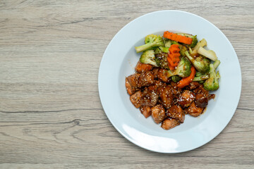 Fototapeta premium Teriyaki Salmon with Broccoli, Carrots and Roasted Sesame Seeds on Wooden table. Top view