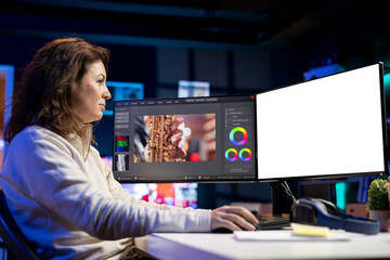 Videographer using professional software on mockup PC to create visual effects for video projects. Expert using post production techniques to edit raw clips footage on isolated screen computer