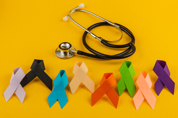 Support for cancer awareness with colorful ribbons and healthcare tools