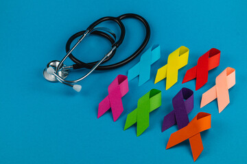 Colorful awareness ribbons alongside a stethoscope symbolizing health advocacy