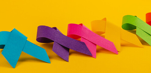 Colorful ribbons symbolize global awareness campaigns for various diseases
