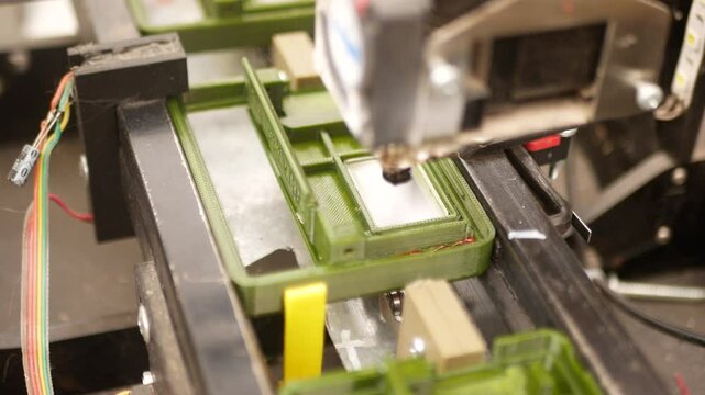 The plastic part moves on a conveyor and is filled with hot plastic
