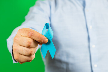 Man holding blue ribbon to promote cancer awareness and support