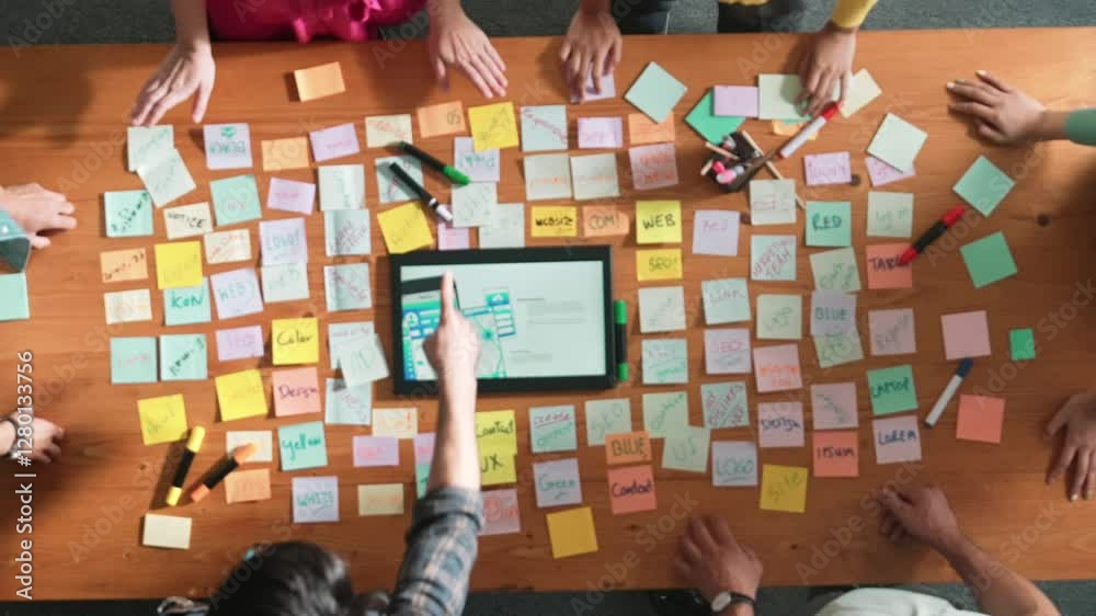 Poster aerial view of developer team discussing and showing digital program and writing by using ux ui desi