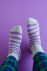 Colorful socks resting on a purple background with checkered pants