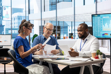 Old people asking for professional advice from financial expert, counseling on retirement plans and investments. Helping middle aged pair to invest money and increase their income. Maximize savings.