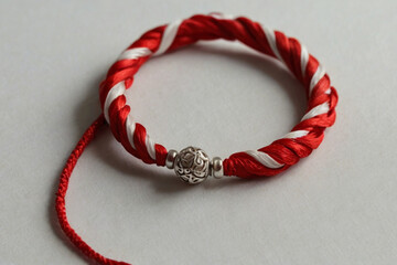 Martenitsa. Red and white bracelet specific to Balkan and Bulgarian culture. Balkan tradition Martenitsa. Bracelet symbolizing the arrival of spring.