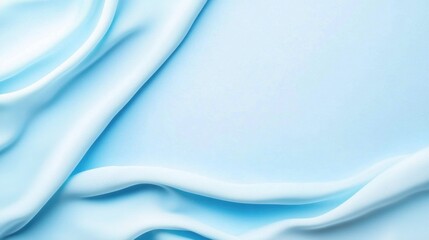 Naklejka premium Soft, flowing blue fabric drapes elegantly, creating a calm and serene ambiance with gentle folds and textures.