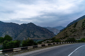 A mountain range is visible in the distance, with a road running through it