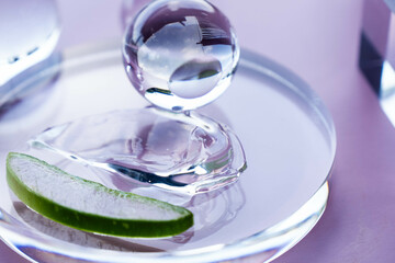 Aloe serum on a glass dish beside fresh aloe, bathed in soft light at a tranquil spa.