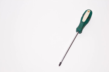 Screwdriver with a green tail on a white background. Tools for master