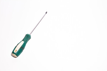 Screwdriver with a green tail on a white background. Tools for master