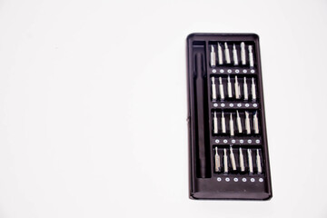 Set of screwdriver bits in a black box on a white background. Tools, screwdriver in a box. Screwdriver with different attachments
