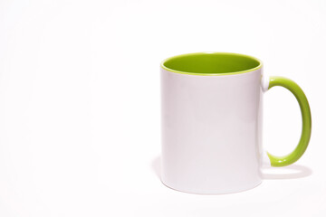 Cup on a white background. Green mug. Green cup or mug isolated on white. Coffee cup. Empty green tea cup. White and green ceramic cup