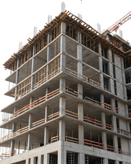 Concrete building under construction with scaffolding, steel reinforcements, and wooden planks