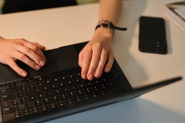 Close up of female student hands typing on computer, studying and working with laptop