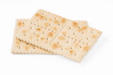 Close-up of crispy saltine crackers isolated on a white background. Simple and classic snack, perfect for food photography, culinary projects, and product presentations.