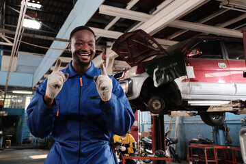 Portrait of confident Black male mechanic inspector, cheerful works and pose with smile in fix car garage, professional engineer maintenance jobs in automotive and transportation industry business.
