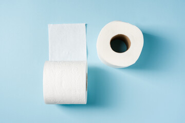Top view of toilet paper roll on blue background