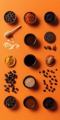 Coffee beans, spices, honey, dried fruits arranged on orange background