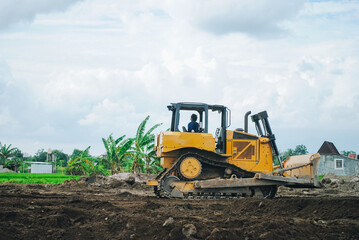 A large bulldozer is doing excavation work at a construction site.