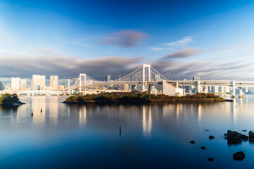 Naklejka premium Tokyo skyline with Rainbow Bridge and Tokyo Tower at sunrise