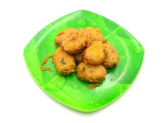 tempting potato cakes on a green plate patterned with banana leaves