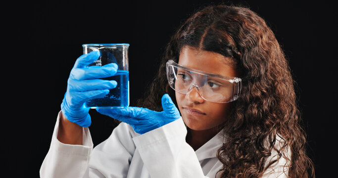 Girl, scientist and liquid with beaker in studio for experiment, test or exam on a dark background. Female person, teenager or chemist with chemical compound for science discovery, results or alchemy