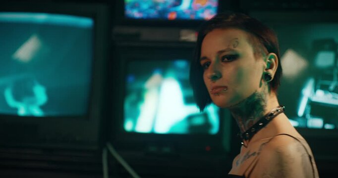 Individuality and uniqueness, unusual beauty of tattooed woman with piercing. Sexuality and alternative style, strange lady watching tv with her images, back view and face shot, rock star woman