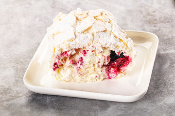 Delicous meringue roll with cherry